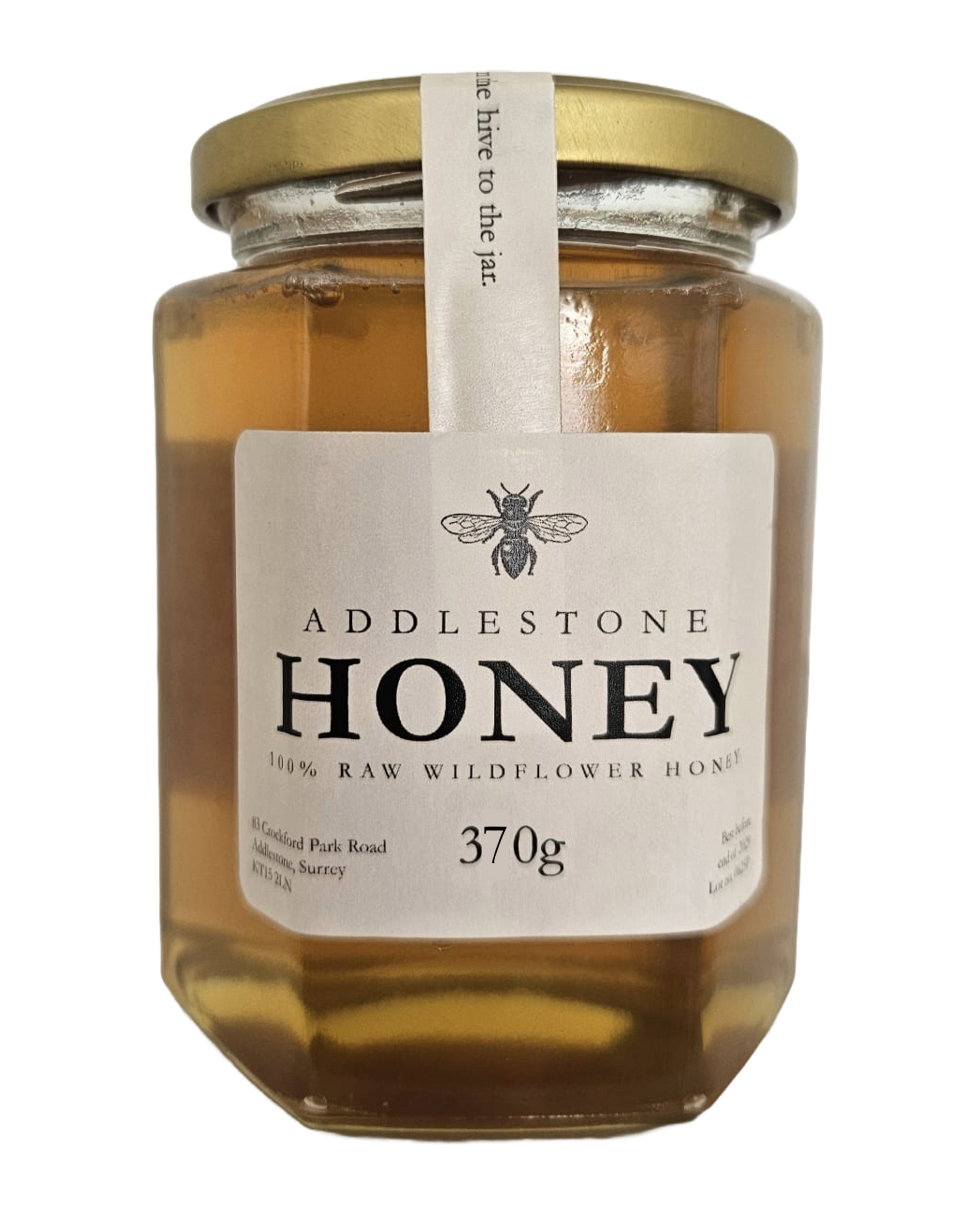 Jar of Addlestone Runny Honey with a gold lid on a white background
