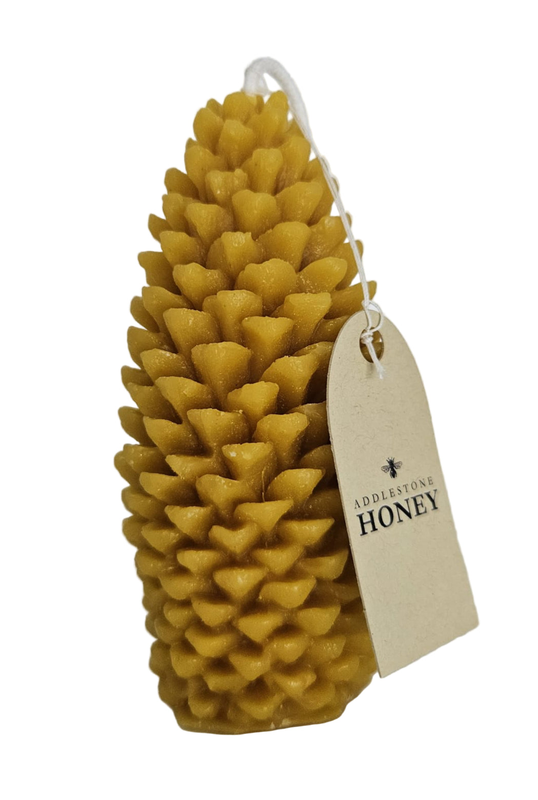 Pine cone-shaped candle with a branded instructions tag on a white background.