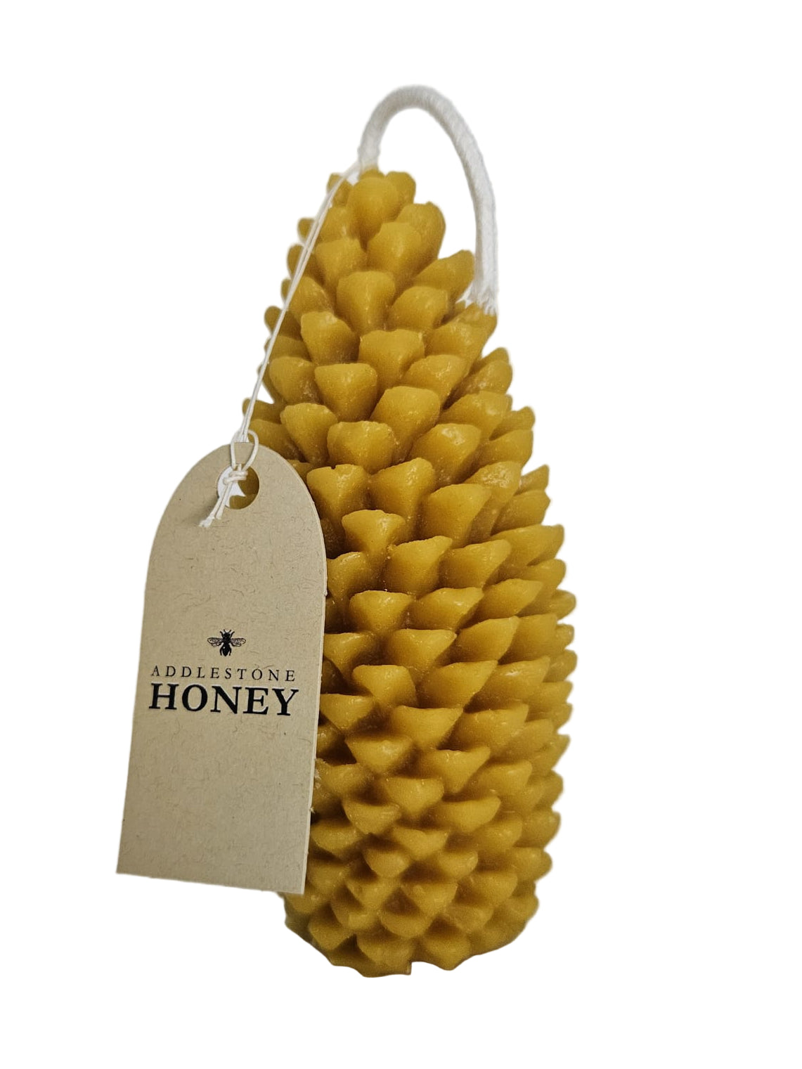 Beehive-shaped honeycomb candle with a branded instructions tag on a white background.