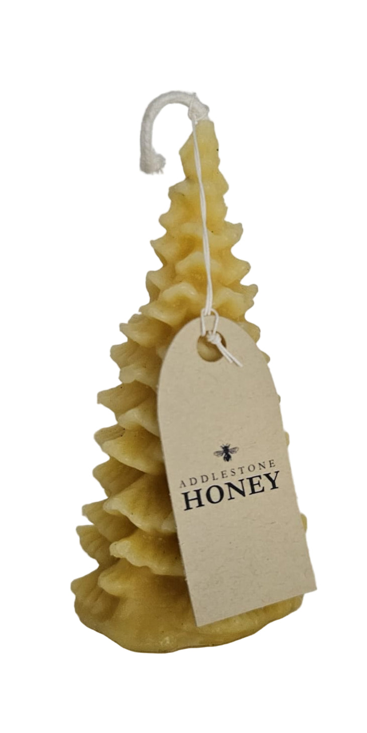 Pure beeswax candle with a branded instructions tag on a white background