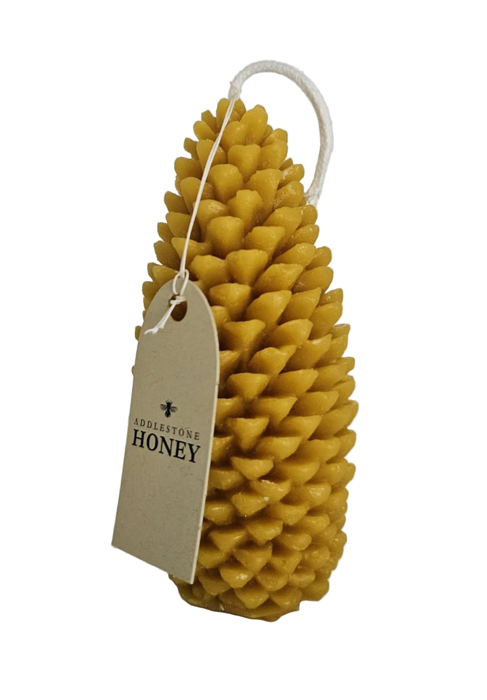 Beeswax pinecone with a a branded instructions tag on a white background