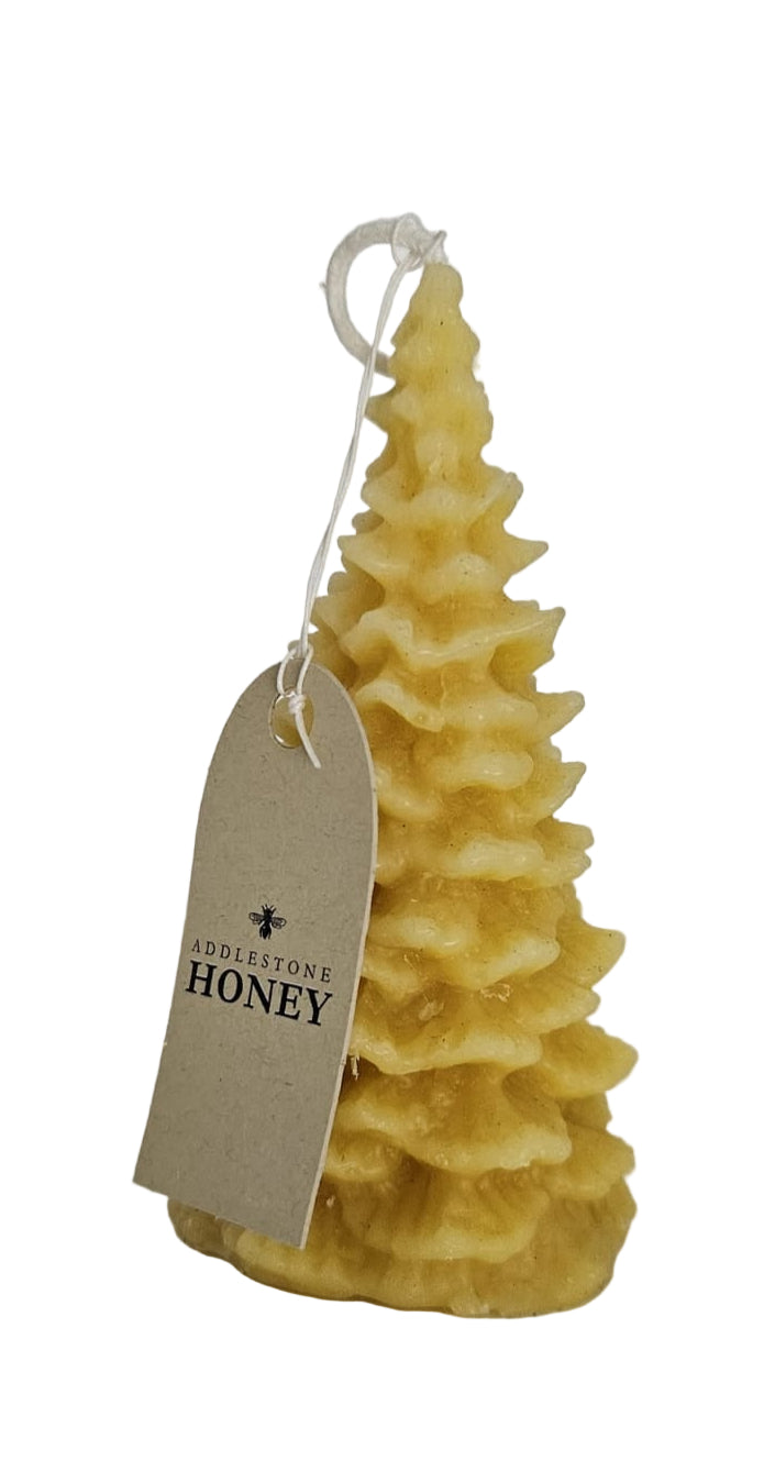 Beeswax candle shaped like a Xmas tree with a 'Honey' tag on a white background