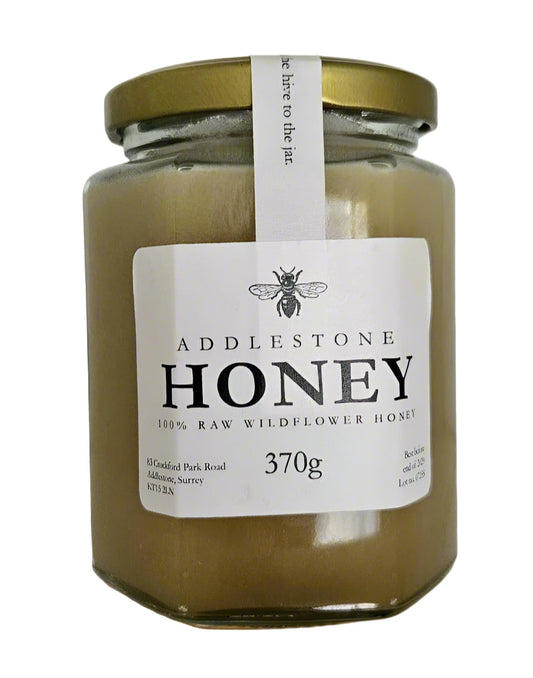 Jar of Addlestone Honey with a label on a white background