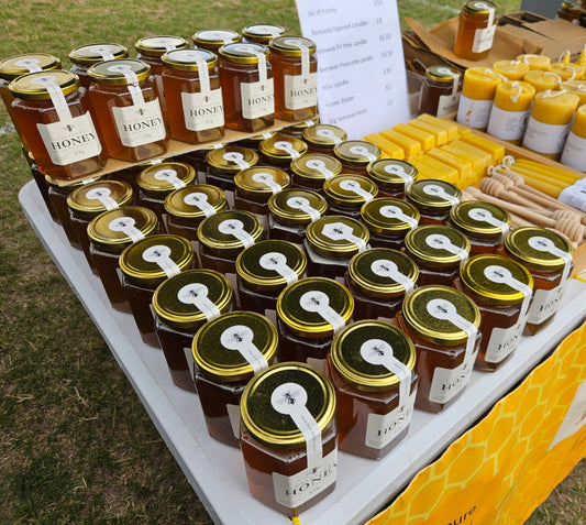 Local Addlestone Honey for sale at a local market stall.