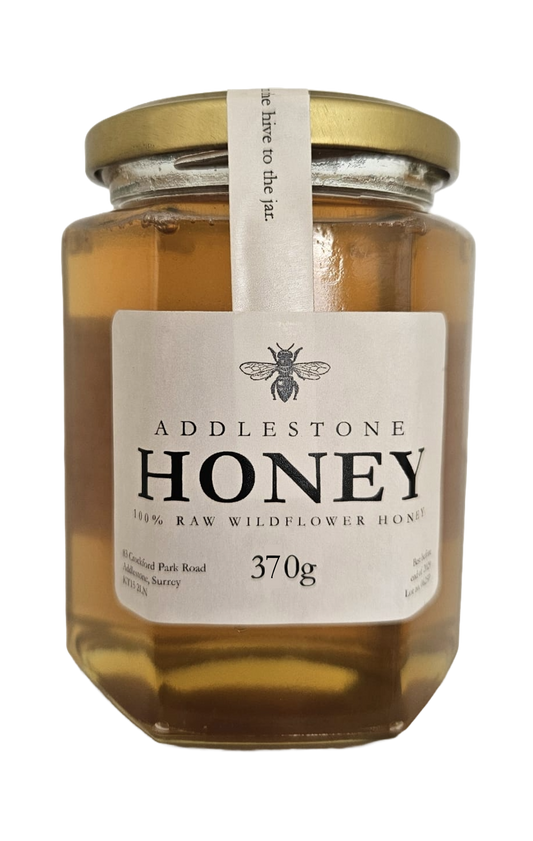 Jar of Addlestone Runny Honey with a gold lid on a white background
