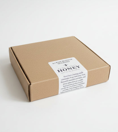 A box of 9 pure beeswax candles from Addlestone Honey