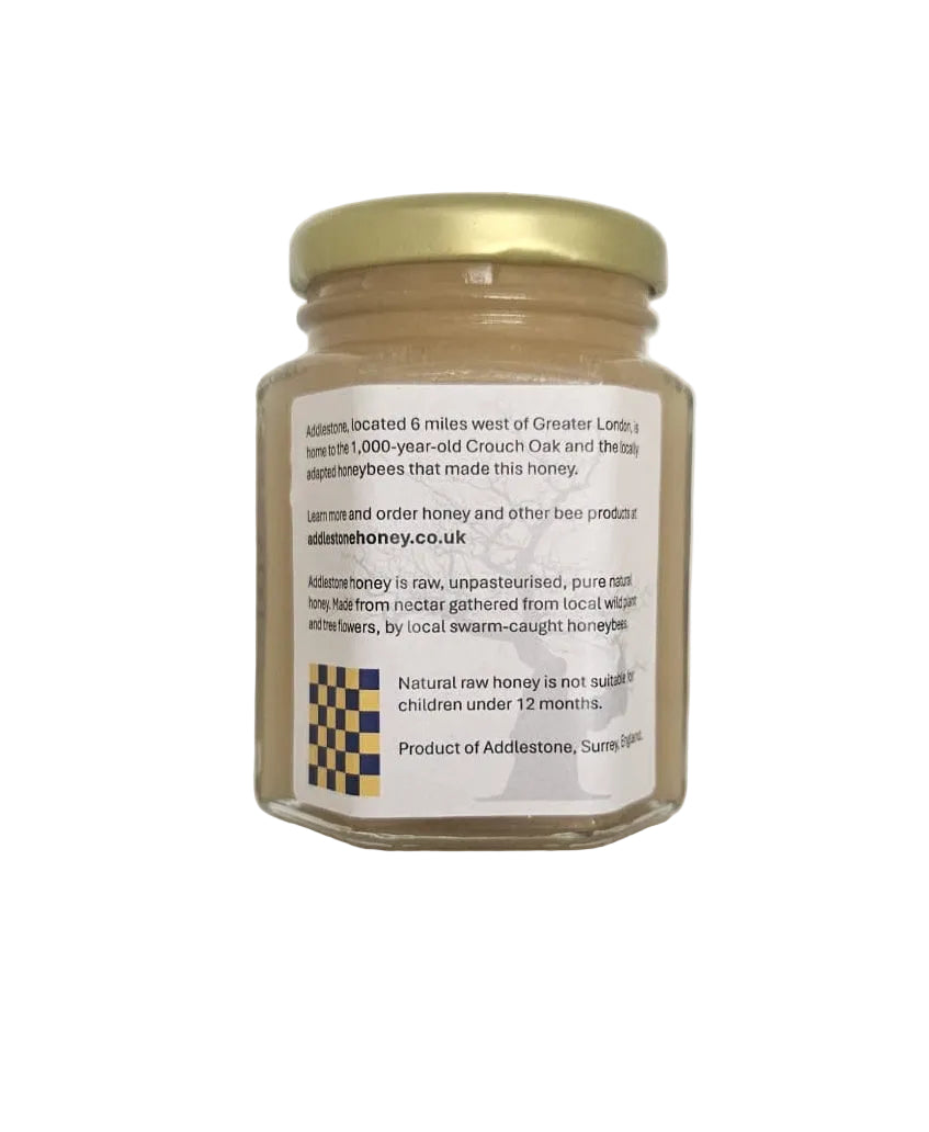 The rear side of a small jar of crystallised honey.