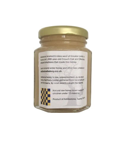 The rear side of a small jar of crystallised honey.