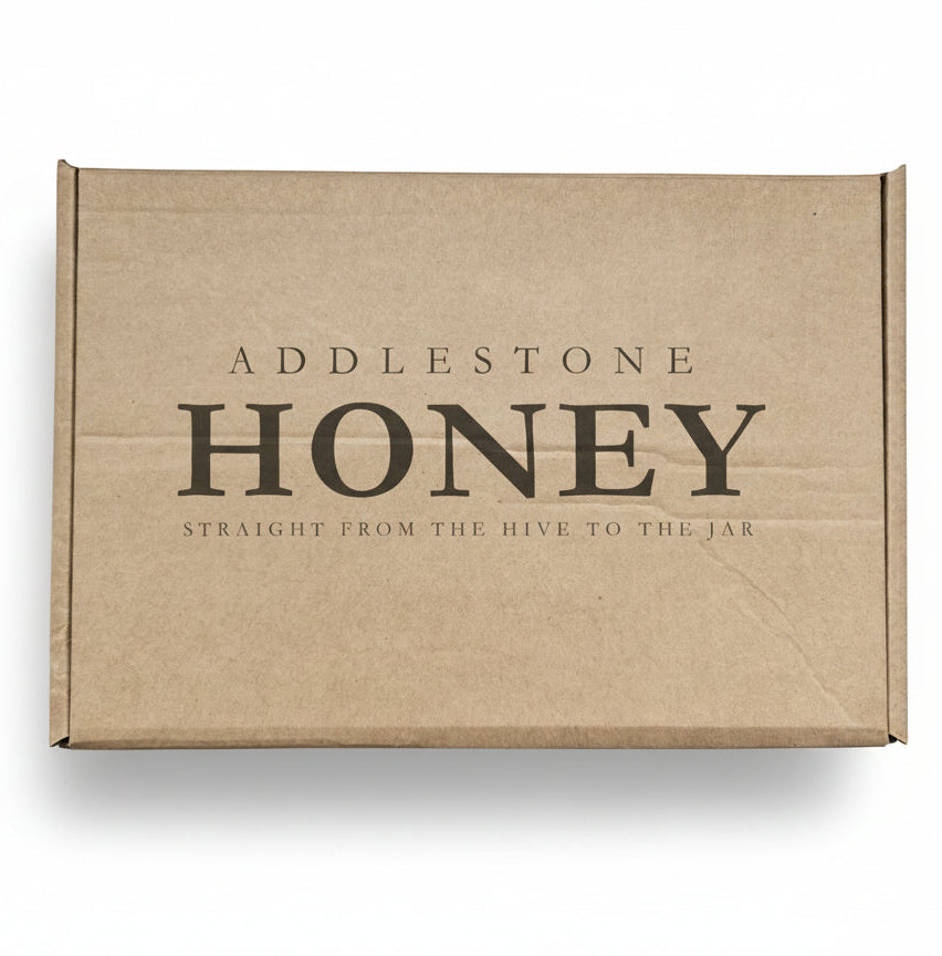 Brown cardboard giftbox with 'Addlestone Honey' branding.