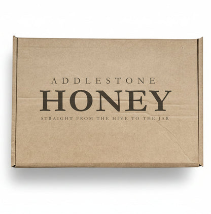 Brown cardboard giftbox with 'Addlestone Honey' branding.