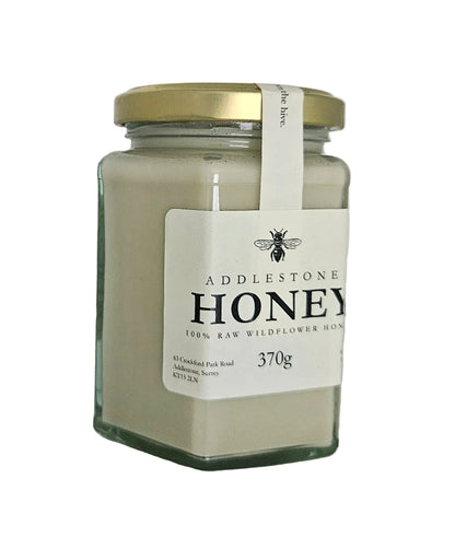 Jar of Addlestone soft set Honey with a gold lid on a white background
