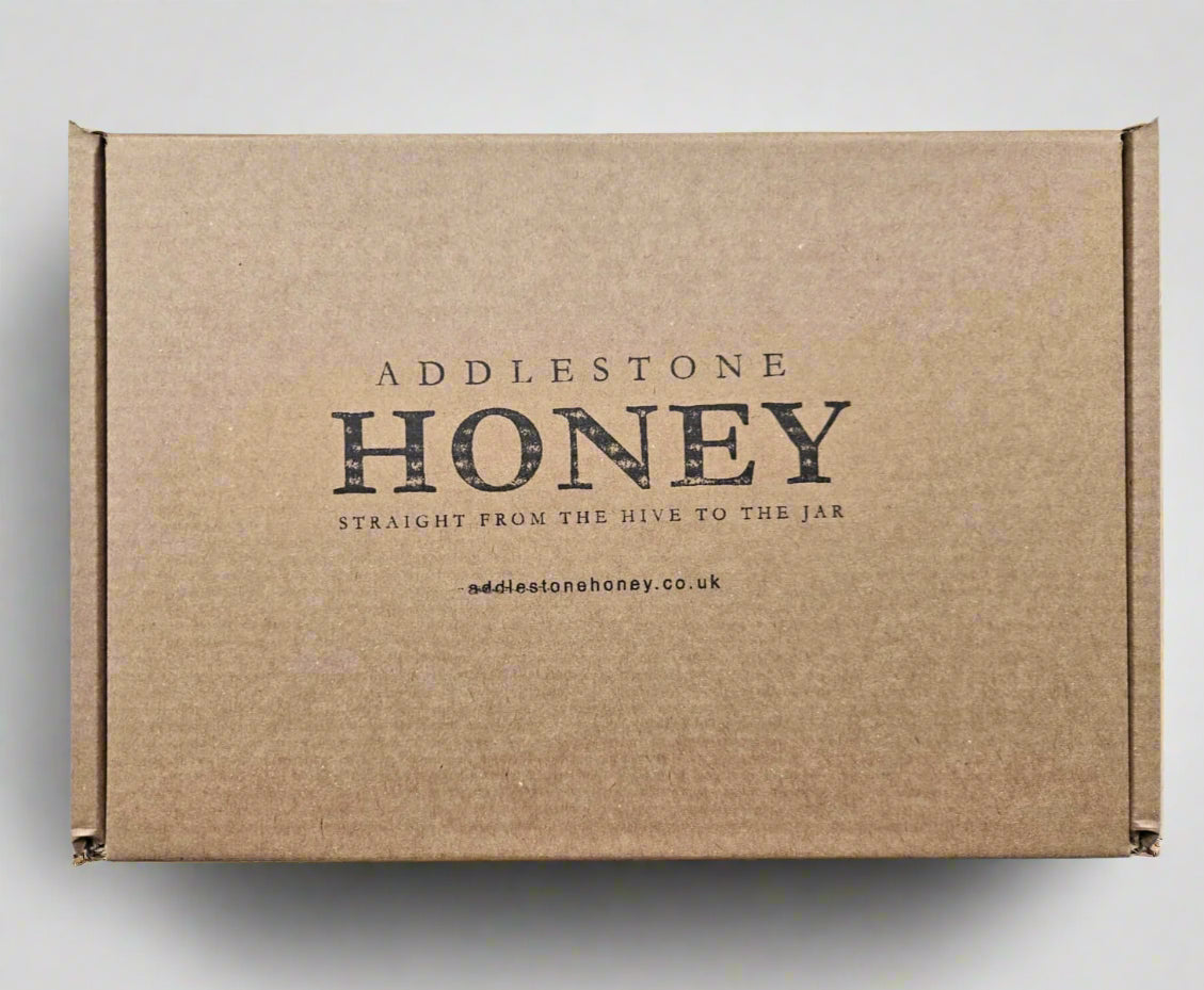 Brown gift box with 'Addlestone Honey' branding.