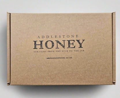 Brown gift box with 'Addlestone Honey' branding.