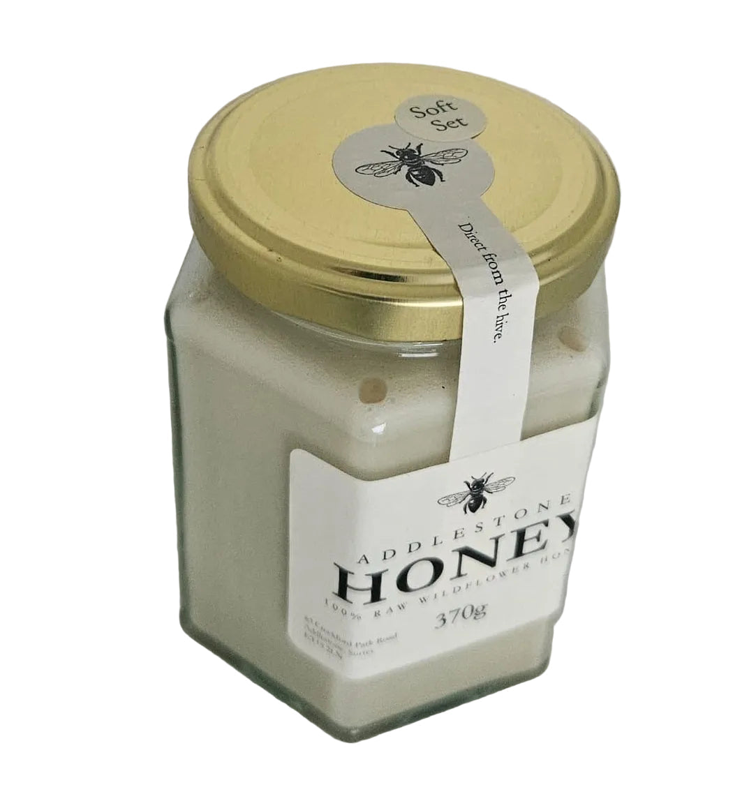 Jar of honey with a label on a white background
