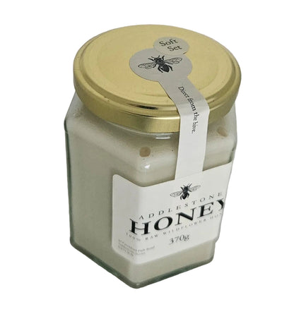 Jar of honey with a label on a white background