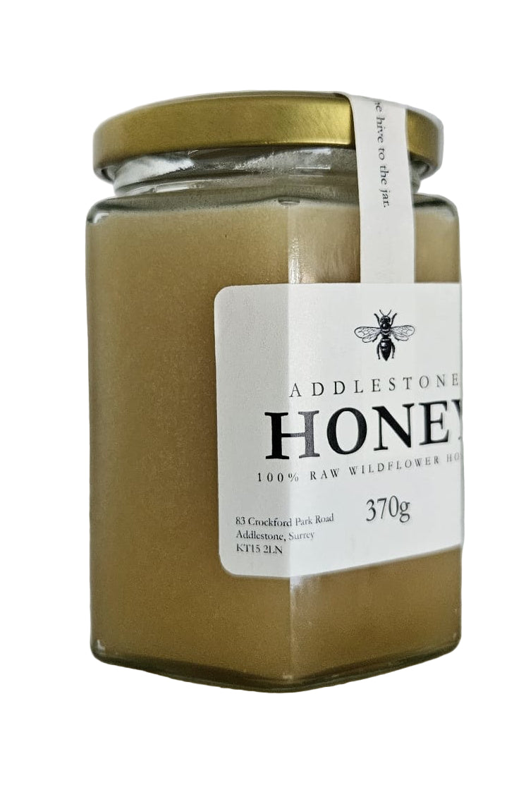 Jar of Addlestone Honey with a white label on a light background