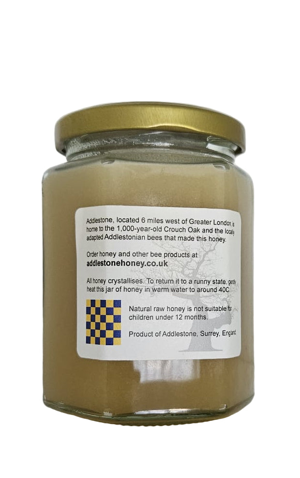 Jar of honey with a label on a white background