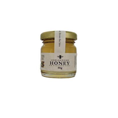 A single 50g mini jar of raw wildflower honey
